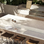 Fossillia porcelain outdoor countertop with a seafoam base, white veins, and swirls