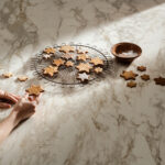 Dolcivio porcelain countertop with a white base with gray veins and copper accents