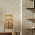 Living room featuring large-format, light-brown marbled Caesarstone porcelain wall cladding in Mosstone around a modern fireplace and behind floating wooden shelves.