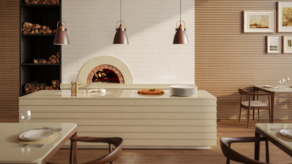 Caesarstone ICON 4201 Organic Dune beige surface featured in a modern restaurant interior with a pizza oven island countertop and warm wood accents